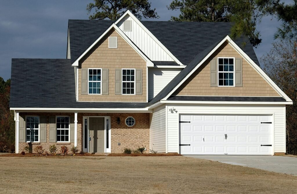pexels-photo-164558-164558 Elegant two-storey house with garage, showcasing modern architecture and residential charm.